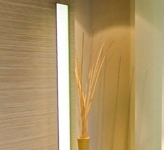 Decorative dried grasses against wood panelling