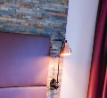 Bedside lamp against a natural-stone wall