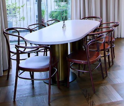 Oval dining table with bentwood chairs by the window