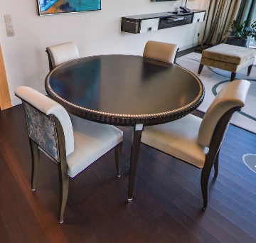 Round dining table with four upholstered chairs